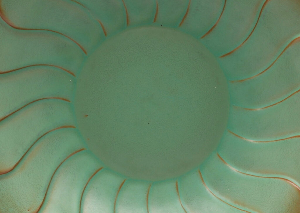 Gallery BAC relief pattern of overlapping scallops, vaguely evoking a flower, in a bright celadon with brown shading