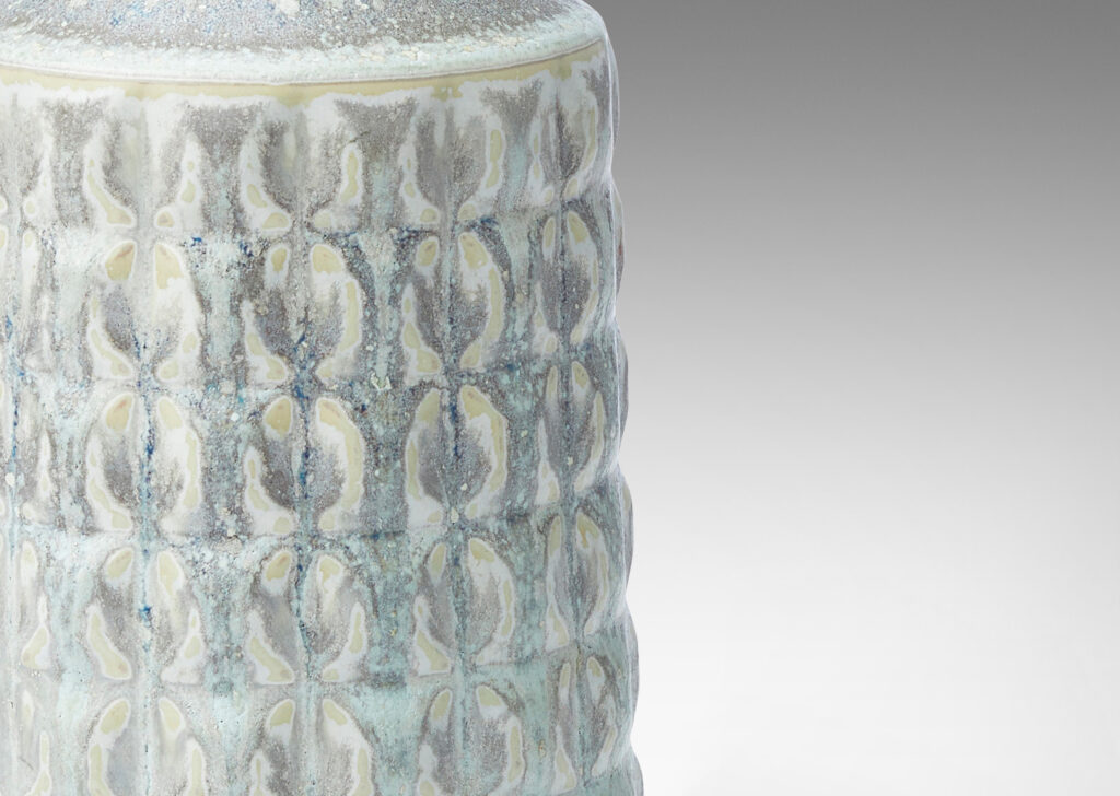 Gallery BAC bottle-like form with pillowy grid relief, glazed in a cool pale gray with warm gray circle pattern