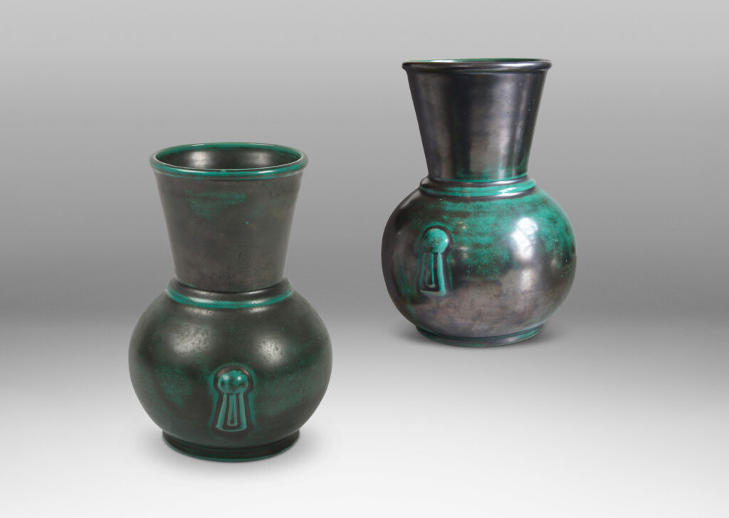 Gallery BAC carafe-like forms with flared necks and relief tassel “handles” in a deep blue-green copper oxide glaze