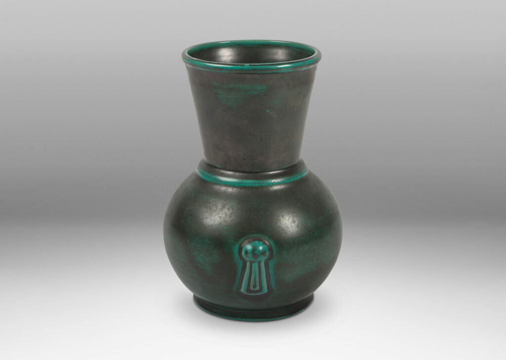 Gallery BAC carafe-like forms with flared necks and relief tassel “handles” in a deep blue-green copper oxide glaze