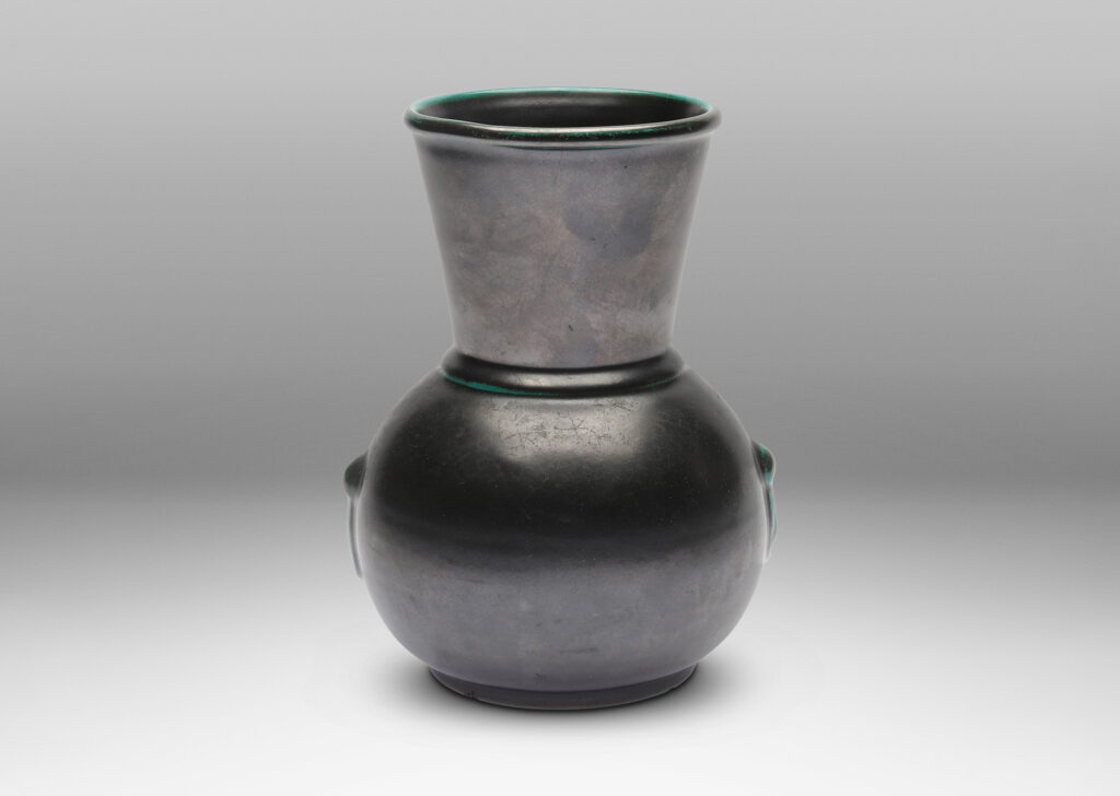 Gallery BAC carafe-like forms with flared necks and relief tassel “handles” in a deep blue-green copper oxide glaze