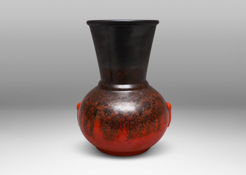 Gallery BAC carafe-like forms with flared necks and relief tassel "handles" in a deep orange and gunmetal gray