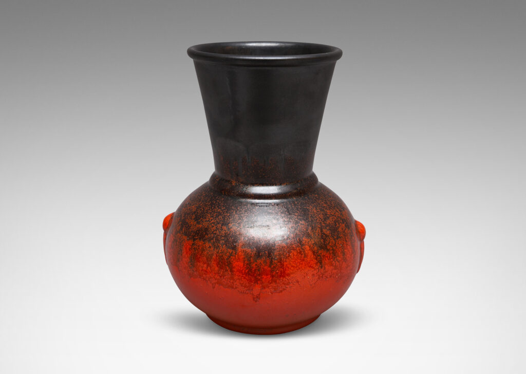 Gallery BAC carafe-like forms with flared necks and relief tassel "handles" in a deep orange and gunmetal gray