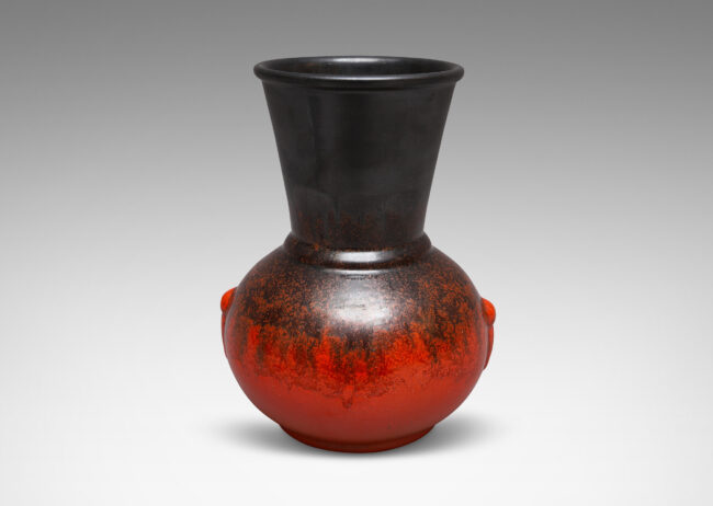 Gallery BAC carafe-like forms with flared necks and relief tassel "handles" in a deep orange and gunmetal gray