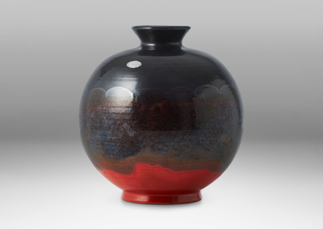 Gallery BAC wide globe form with flared reveal and neck, glazed in gunmetal luster and orange