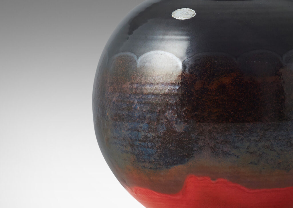 Gallery BAC wide globe form with flared reveal and neck, glazed in gunmetal luster and orange