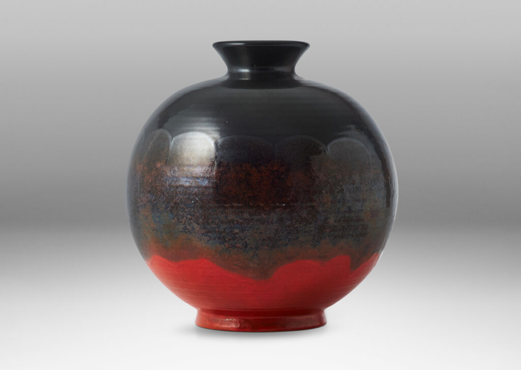 Gallery BAC wide globe form with flared reveal and neck, glazed in gunmetal luster and orange