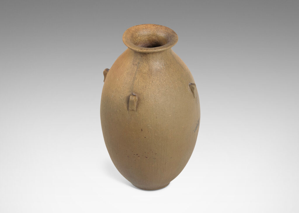 Gallery BAC ovoid form with carved texture, flared mouth, and small nodule-like handles