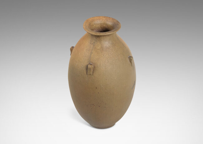 Gallery BAC ovoid form with carved texture, flared mouth, and small nodule-like handles