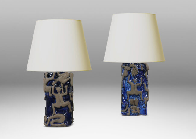 Gallery BAC rounded square pedestal forms with charming reliefs depicting climbing figures in matte brown against a shiny blue glazed field