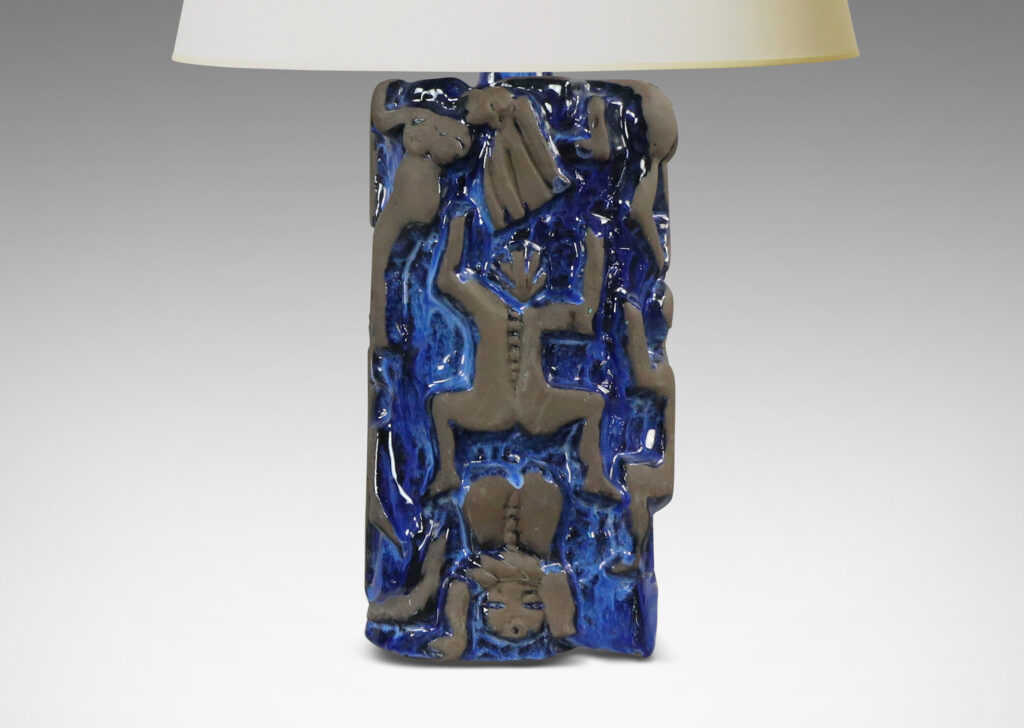 Gallery BAC rounded square pedestal forms with charming reliefs depicting climbing figures in matte brown against a shiny blue glazed field