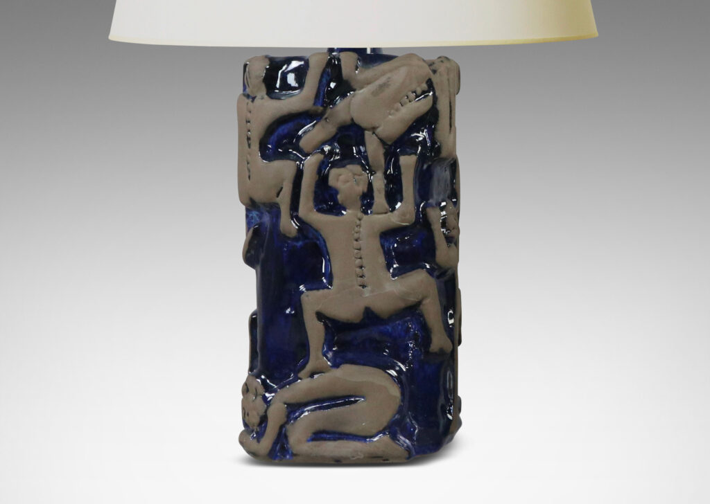 Gallery BAC rounded square pedestal forms with charming reliefs depicting climbing figures in matte brown against a shiny blue glazed field