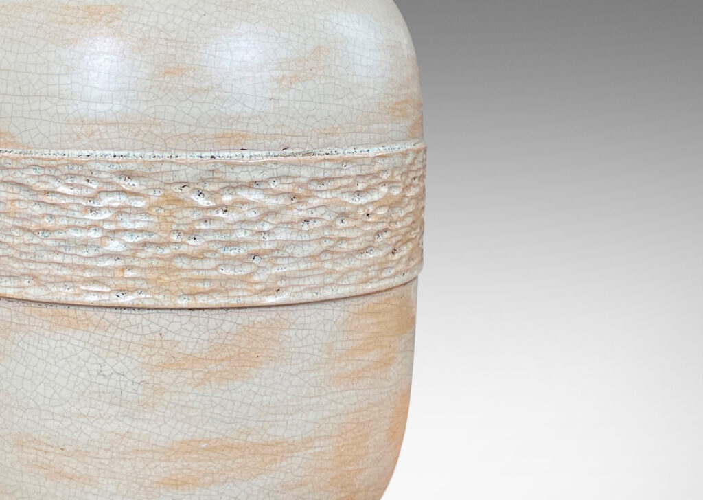 Gallery BAC void form and textured relief band, glazed in a cream and pale yellow craquel