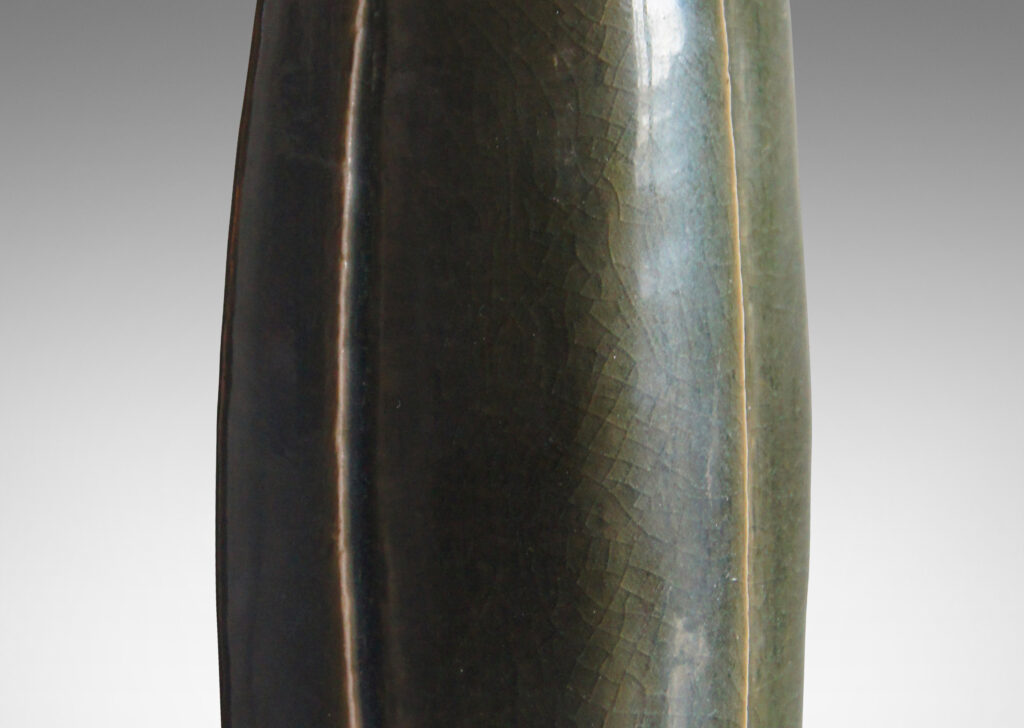 Gallery BAC tall squared form with four swelling sides with carved vertical lines; stoneware with a dark green glaze