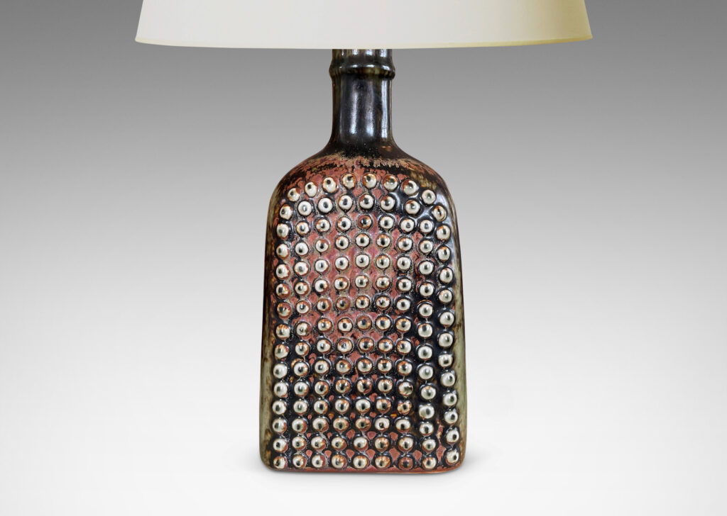 Gallery BAC squared bottle-like form with a grid of cleats on two sides in a dark brown glaze with hints of rust