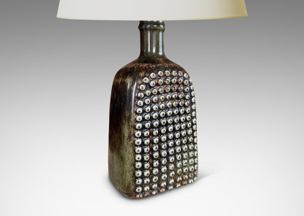 Gallery BAC squared bottle-like form with a grid of cleats on two sides in a dark brown glaze with hints of rust