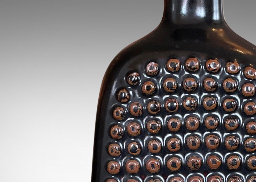 Gallery BAC squared bottle-like form with a grid of cleats on two sides in a chocolate brown glaze