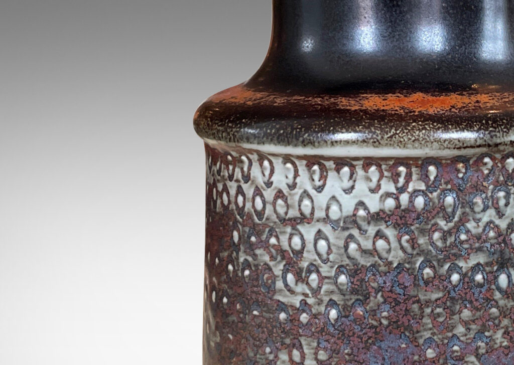 Gallery BAC bottle-like form with wide neck and textured body in gray, black and rust toned glazes