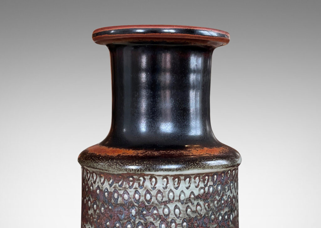 Gallery BAC bottle-like form with wide neck and textured body in gray, black and rust toned glazes