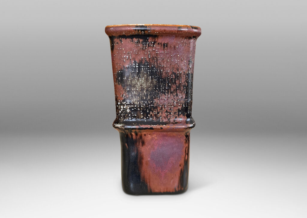 Gallery BAC tapered form with relief nodes and carved crosshatch texture, in gray, black and rust-glazed stoneware