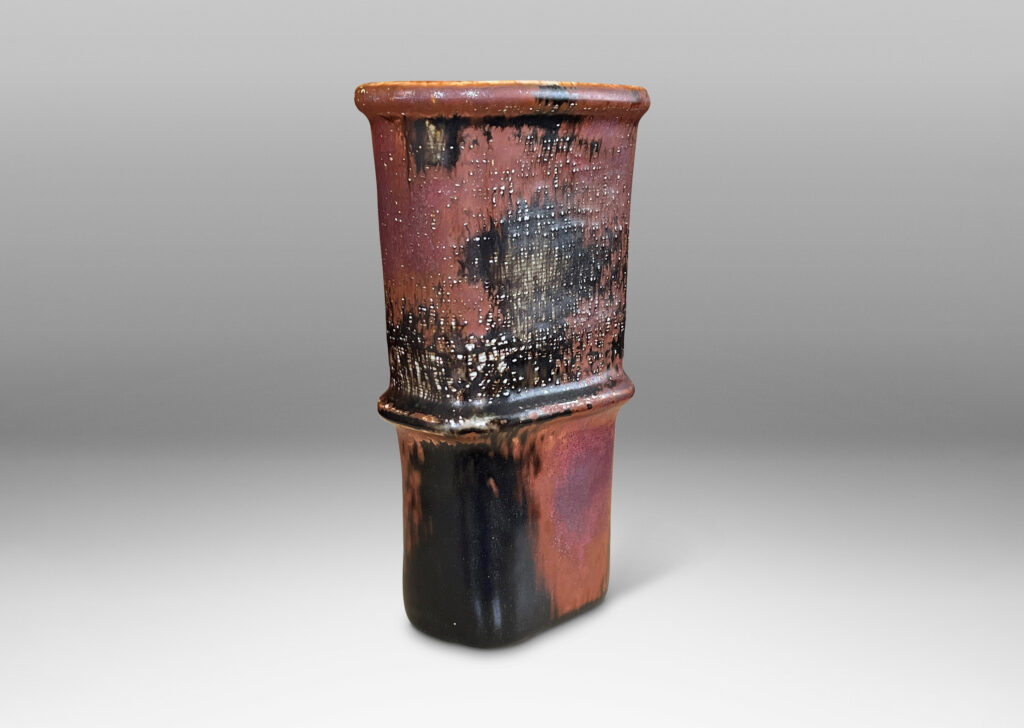 Gallery BAC tapered form with relief nodes and carved crosshatch texture, in gray, black and rust-glazed stoneware