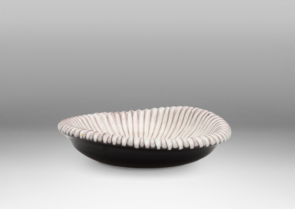 Gallery BAC an organically modeled form with carved ribbing in shiny white and dark brown glazing