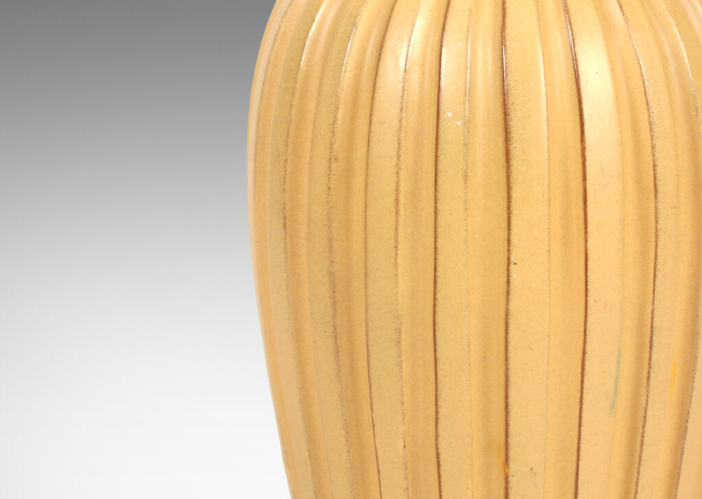 Gallery BAC tall tapered form with carved ribs glazed in a butterscotch tan tone