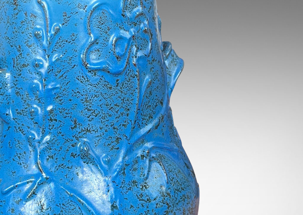 Gallery BAC gourd form with wide mouth, handles, and stylized floral reliefs, glazed in a cerulean blue