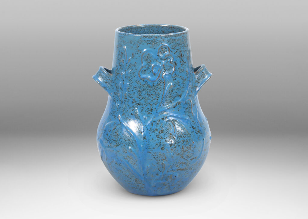 Gallery BAC gourd form with wide mouth, handles, and stylized floral reliefs, glazed in a cerulean blue