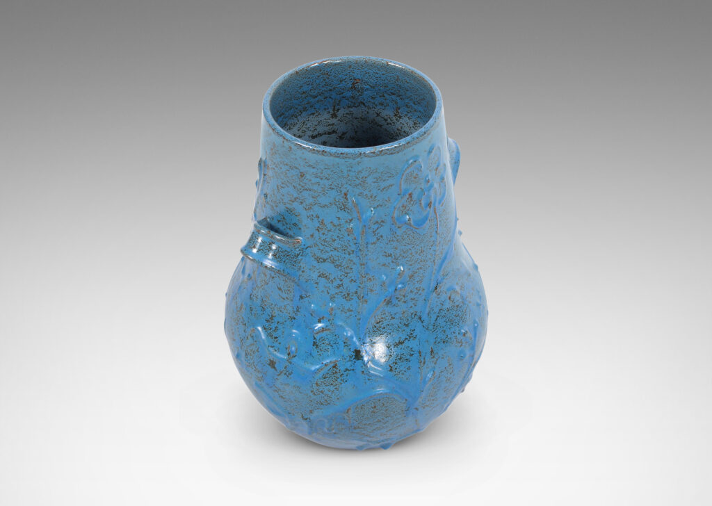 Gallery BAC gourd form with wide mouth, handles, and stylized floral reliefs, glazed in a cerulean blue