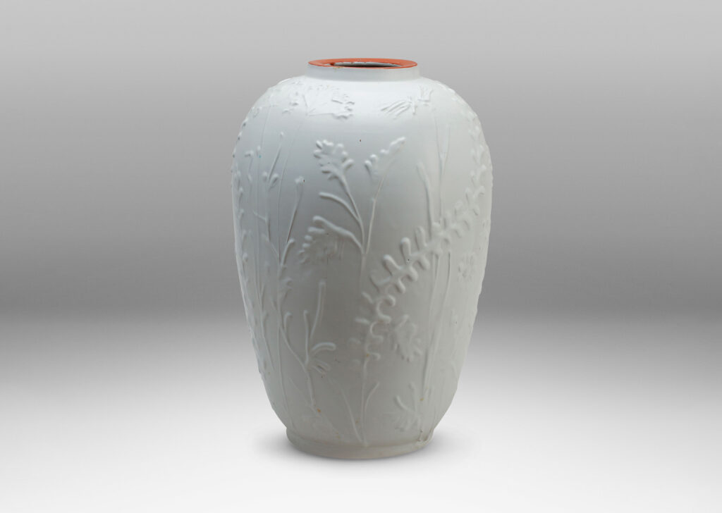 Gallery BAC tall tapering form with relief depictions of wildflowers and an eggshell white finish