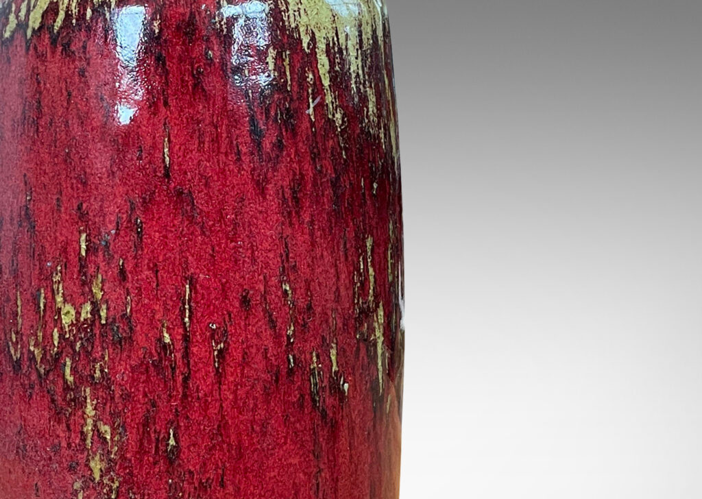 Gallery BAC straight-sided ovoid form and spout mouth in saturated burgundy oxblood glaze with pale gray-tan accents