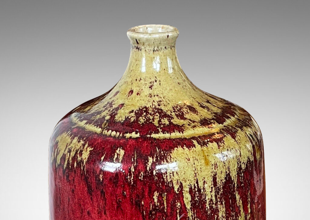 Gallery BAC straight-sided ovoid form and spout mouth in saturated burgundy oxblood glaze with pale gray-tan accents