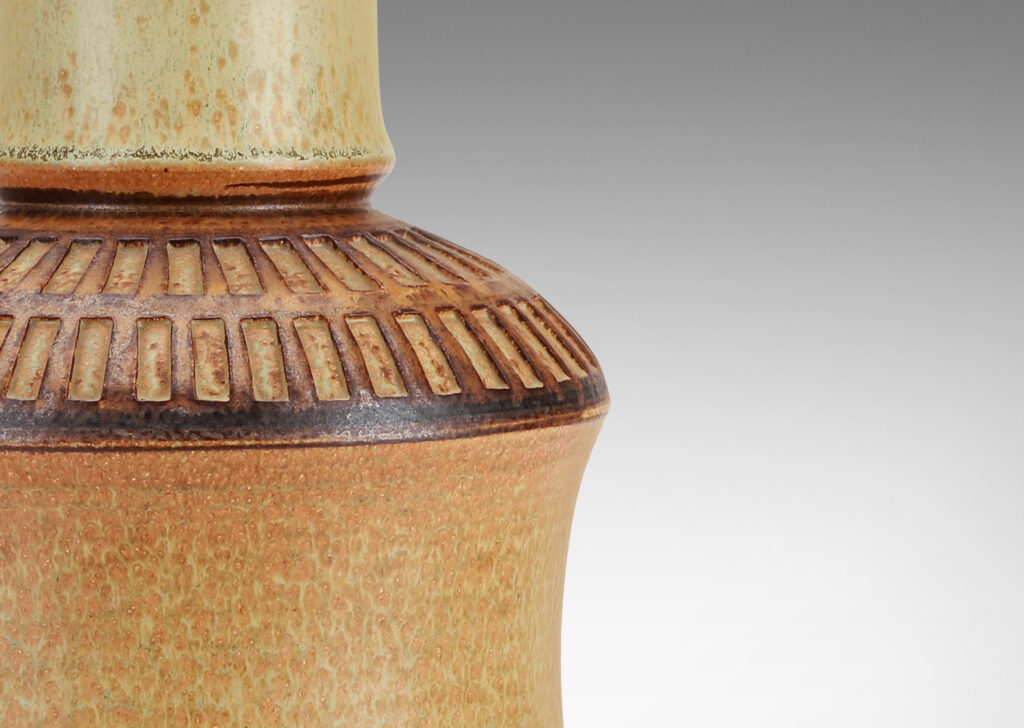 Gallery BAC drum forms with tall necks and intaglio grid on shoulders, glazed in tan and brown