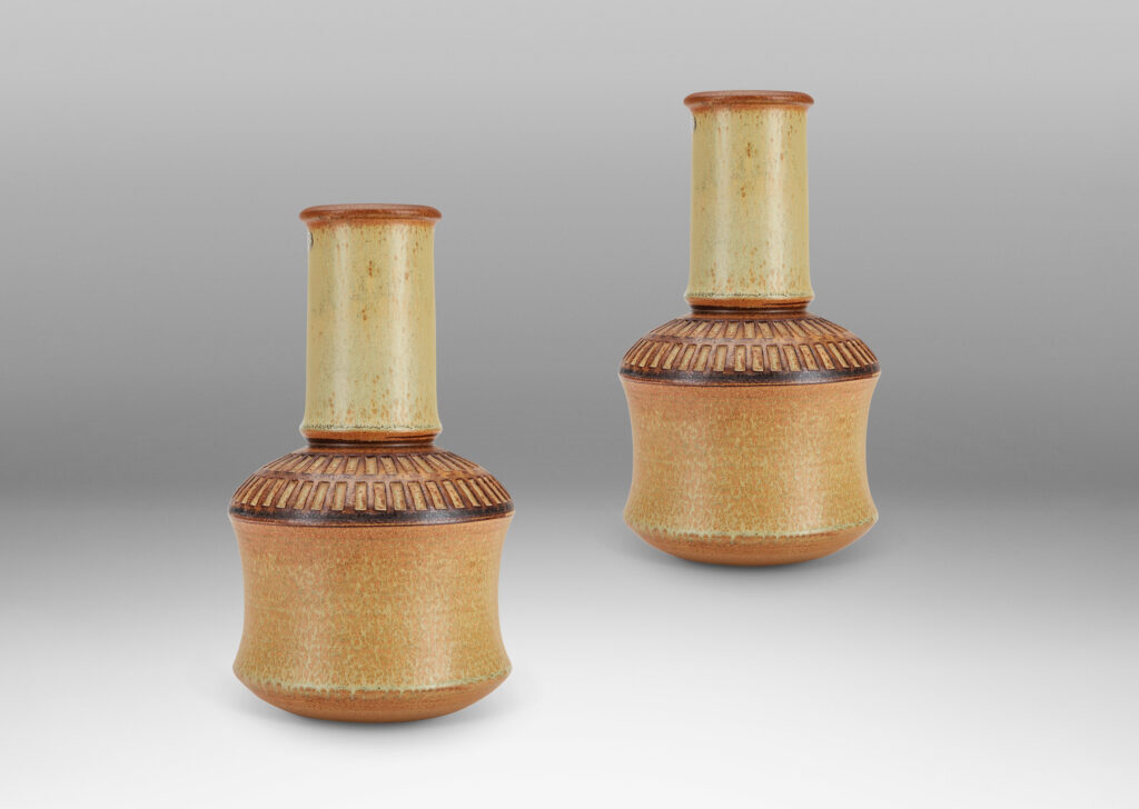 Gallery BAC drum forms with tall necks and intaglio grid on shoulders, glazed in tan and brown