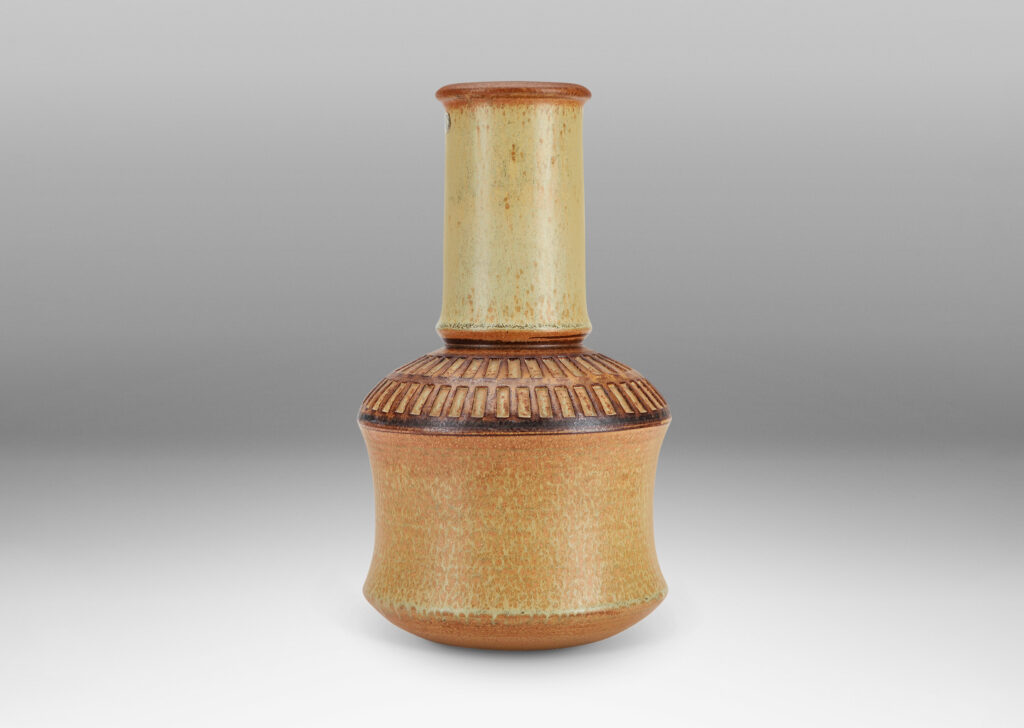 Gallery BAC drum forms with tall necks and intaglio grid on shoulders, glazed in tan and brown