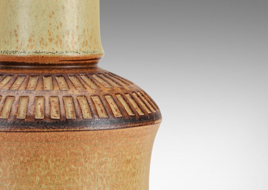 Gallery BAC drum forms with tall necks and intaglio grid on shoulders, glazed in tan and brown