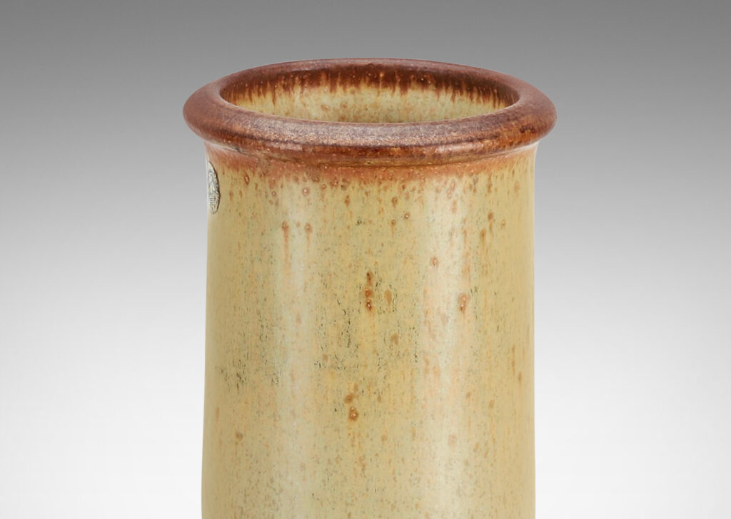 Gallery BAC drum forms with tall necks and intaglio grid on shoulders, glazed in tan and brown