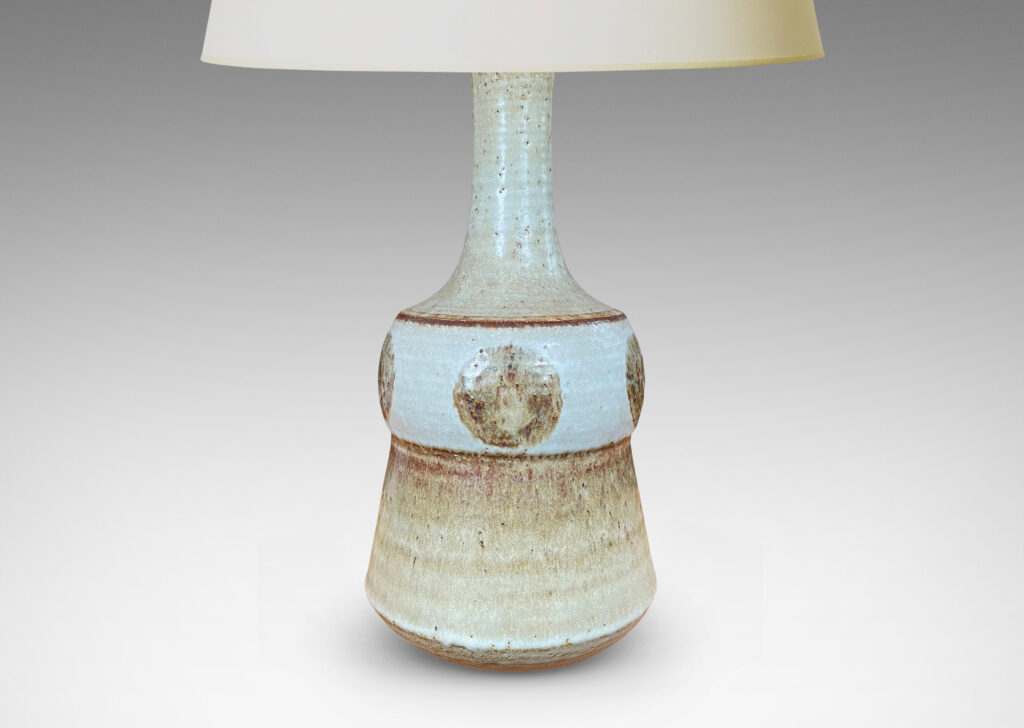 Gallery BAC pawn-like forms with attenuated necks, in pale gray with brown circle motifs and accents