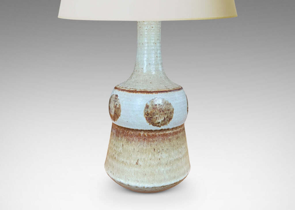 Gallery BAC pawn-like forms with attenuated necks, in pale gray with brown circle motifs and accents