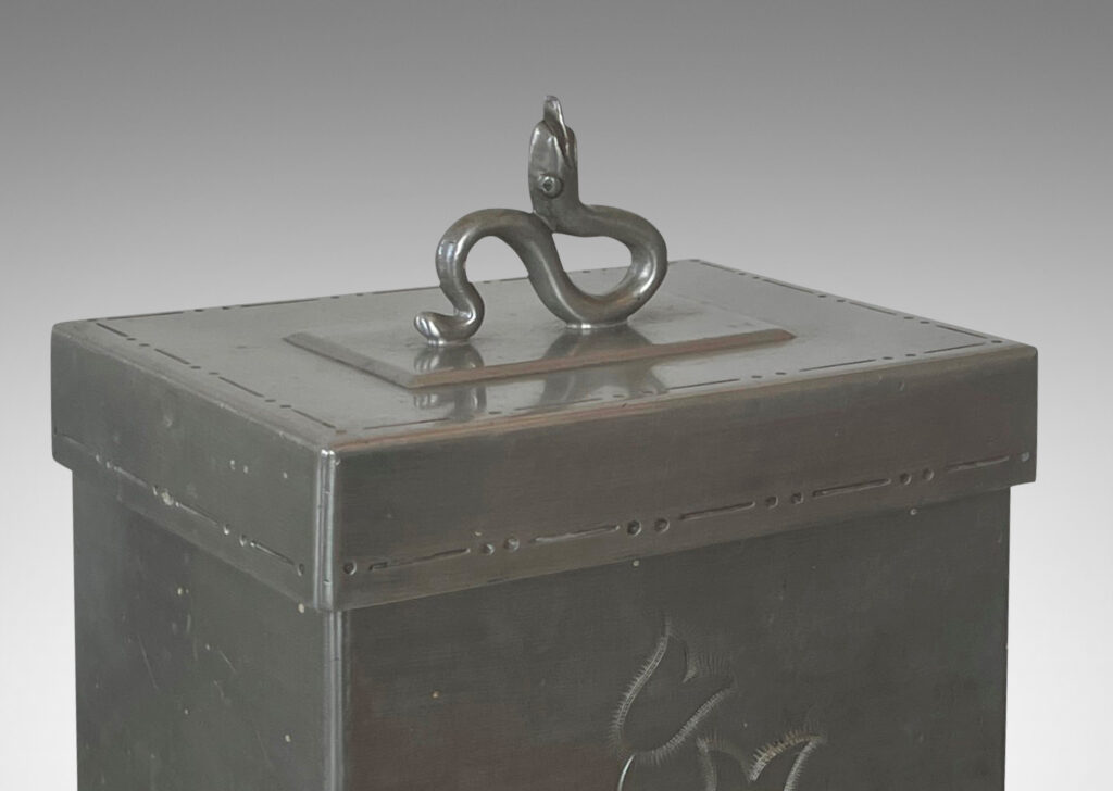 Gallery BAC rectangular form on scroll feet, with engraved floral motif and detailing, and serpent finial on lid