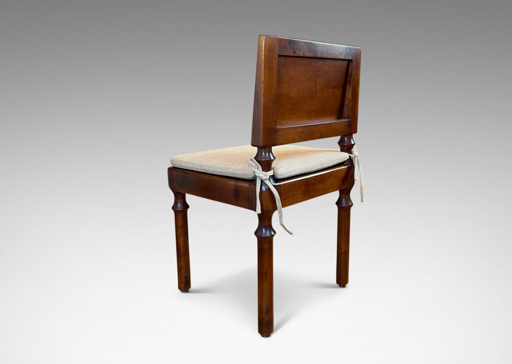 Gallery BAC angled paneled back and tassel-like legs; masterfully crafted in solid birch