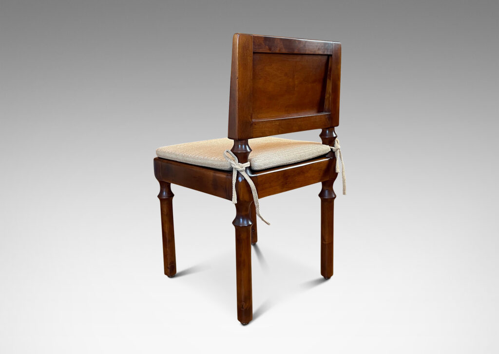 Gallery BAC angled paneled back and tassel-like legs; masterfully crafted in solid birch