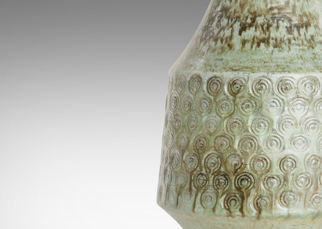 Gallery BAC flared drum form with impressed spiral motifs and a tall sweeping neck