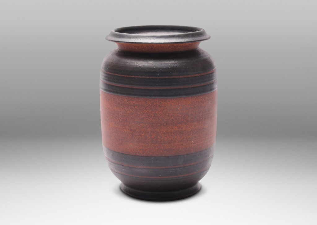 Gallery BAC straight-sided form with sculpted lip and relief stripes, glazed in a dark black-brown and textured russet brown