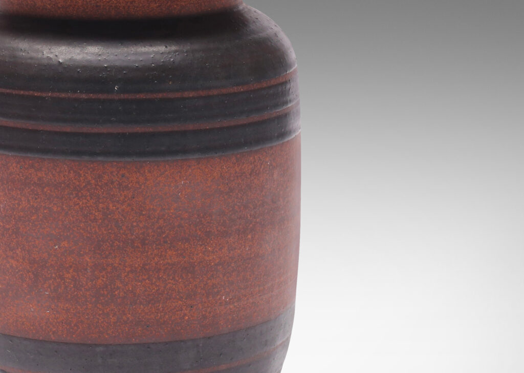 Gallery BAC straight-sided form with sculpted lip and relief stripes, glazed in a dark black-brown and textured russet brown