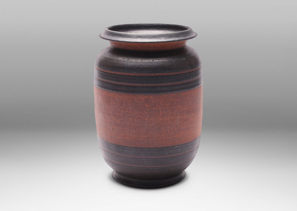 Gallery BAC straight-sided form with sculpted lip and relief stripes, glazed in a dark black-brown and textured russet brown