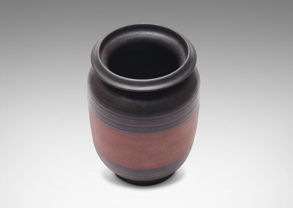 Gallery BAC straight-sided form with sculpted lip and relief stripes, glazed in a dark black-brown and textured russet brown