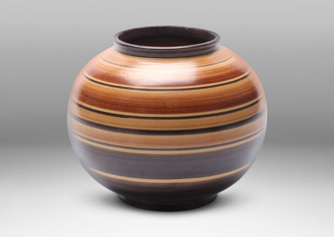 Gallery BAC plump globe form decorated with graded and solid tone stripes in various widths in brown over tan glazing