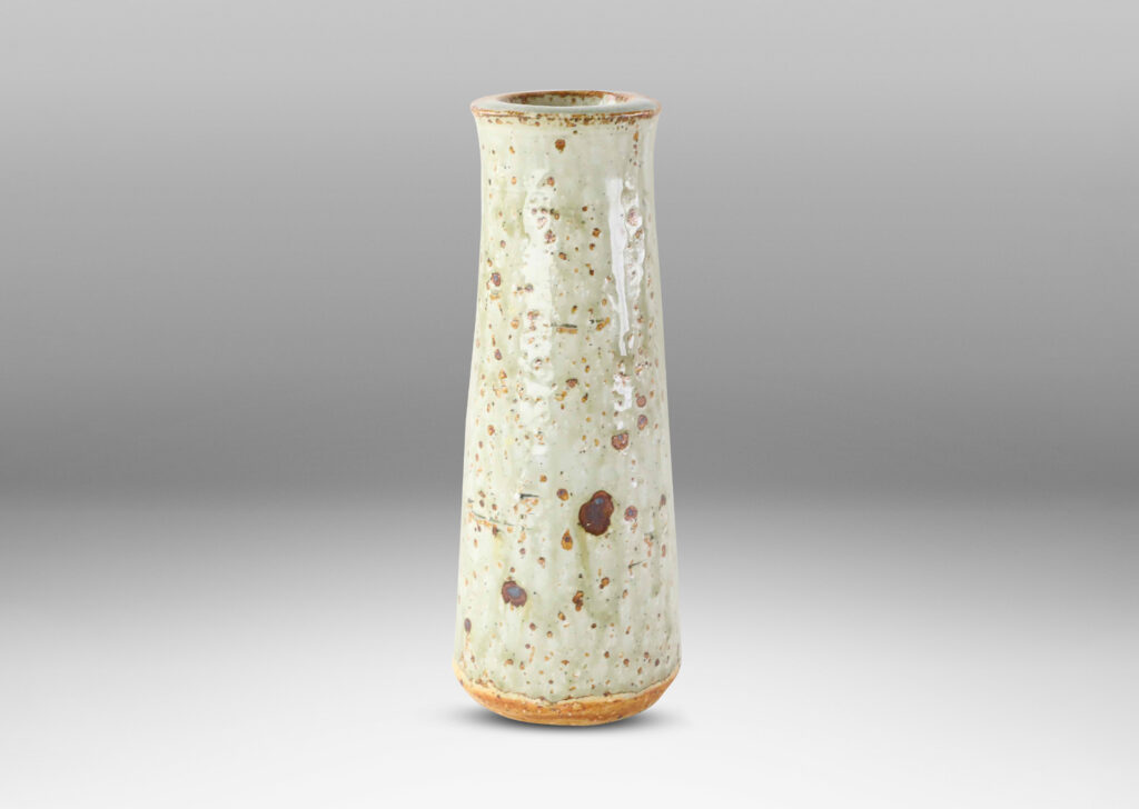 Gallery BAC tall raked cylindrical form with flared lip in a shiny gray-green glaze with brown speckles